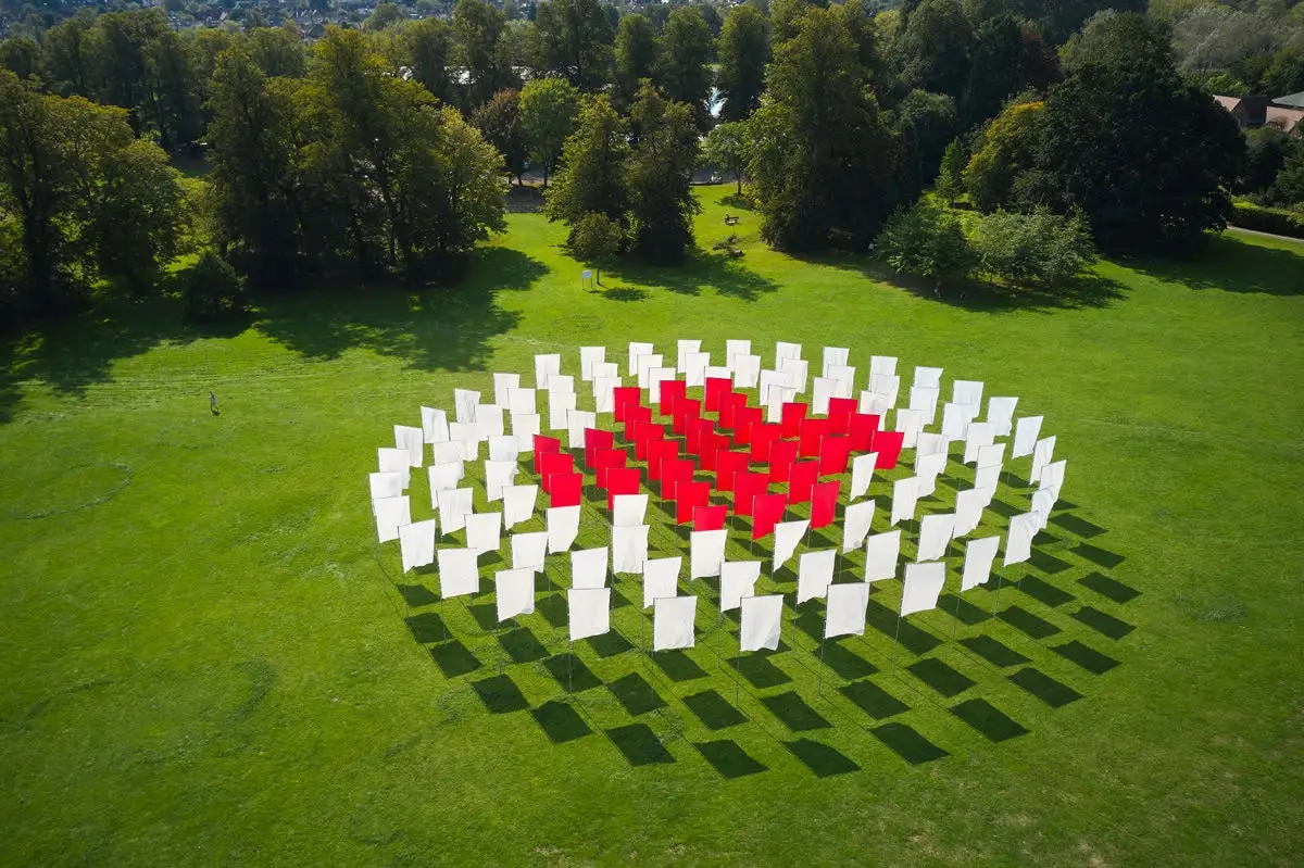 Drone Aerial Photography of Red & White Flags by Adam Hillier